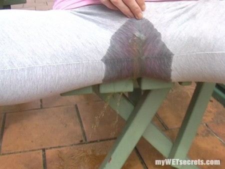 The Picnic Bench - When the urge to comes, who wants to go sit on the toilet? I'd much rather feel the warmth spread around my bum and pussy as I wet myself! Come watch me pee my tight grey leggins, and play in the big puddle I make!