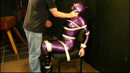 Purple Latex Bondage Gagged  Bagged - Clad in a sexy shiny purple latex catsuit and hood and black high heeled boots, disturbia once again finds herself tied helplessly to a chair!  The white rope around her body stands out vividly against the purple rubber.  She is cleave gagged with a black silk scarf and whilst wearing the gag had a plastic bag pulled tightly over her head.  Watch our damsel in distress suffer and struggle in her tormented bondage for your pleasure...