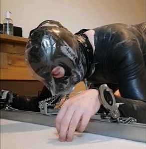 locked down in self bondage with fucking machine - In this video I am doing self bondage with a full latex catsuit on and leather thigh high heels, I lock my self to a bondage frame. Place a pvc breath play hood on and padlock it on, then the lock my neck and wrists to the frame. the fucking machine pounding away