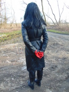 A Small Walk In A Leather Coat And With Handcuffs