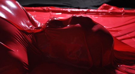 Dread The Red - A slut is trapped in a very tight red PVC envelope and only able to do the thing she likes best... masturbate!  She can barely breath, and almost ends up cancelling the shoot mid-way because of the conflict between having an orgasm, or passing out.
